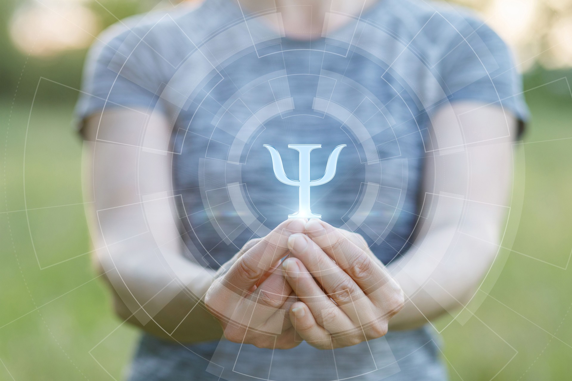 Symbol of psychology held in hands in serene outdoor setting